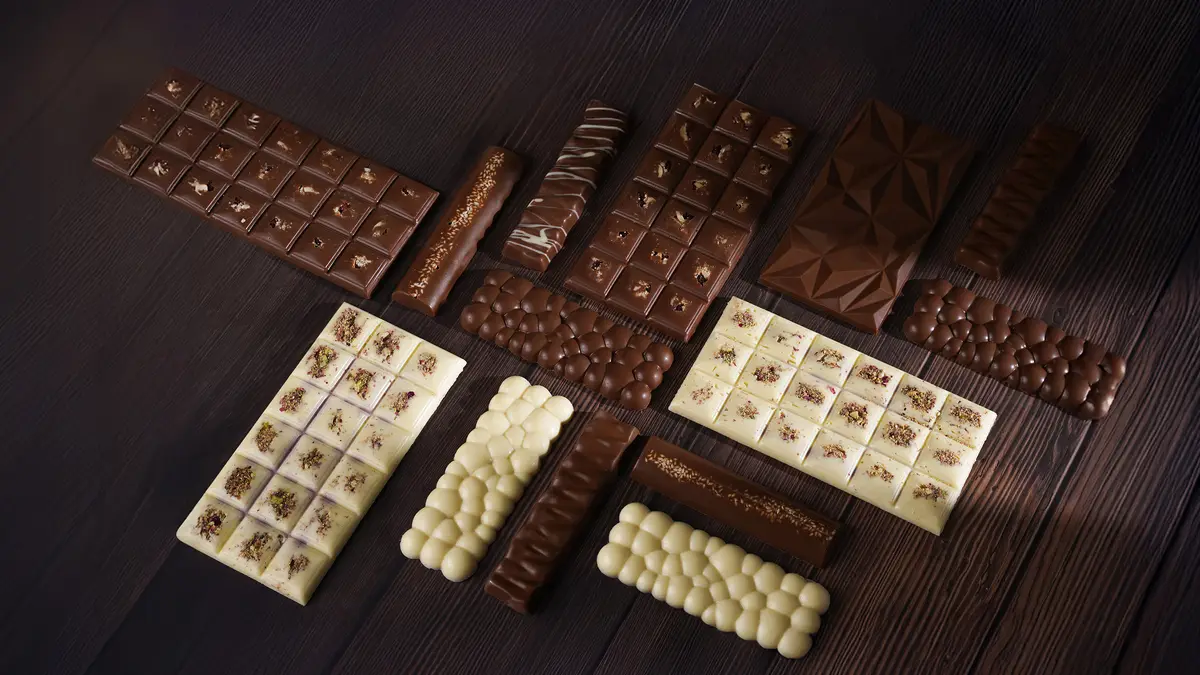 Dark and white chocolate bars in assorted shapes and toppings
