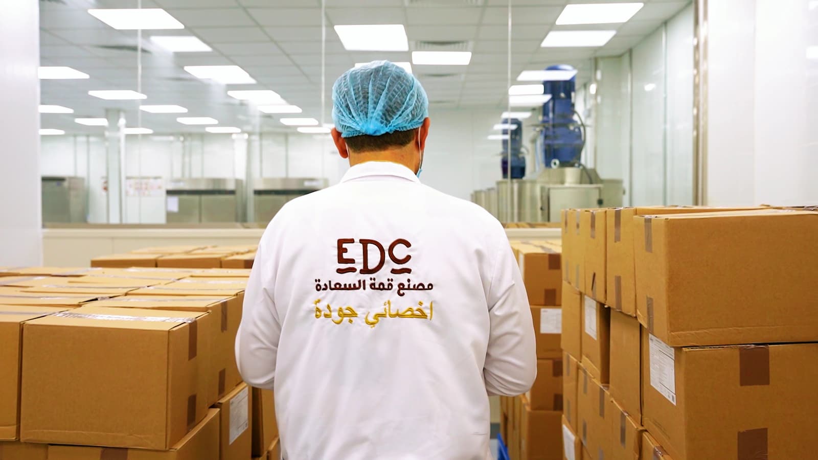 Cartons of chocolate on wrapped pallets, being loaded into a truck for shipping
